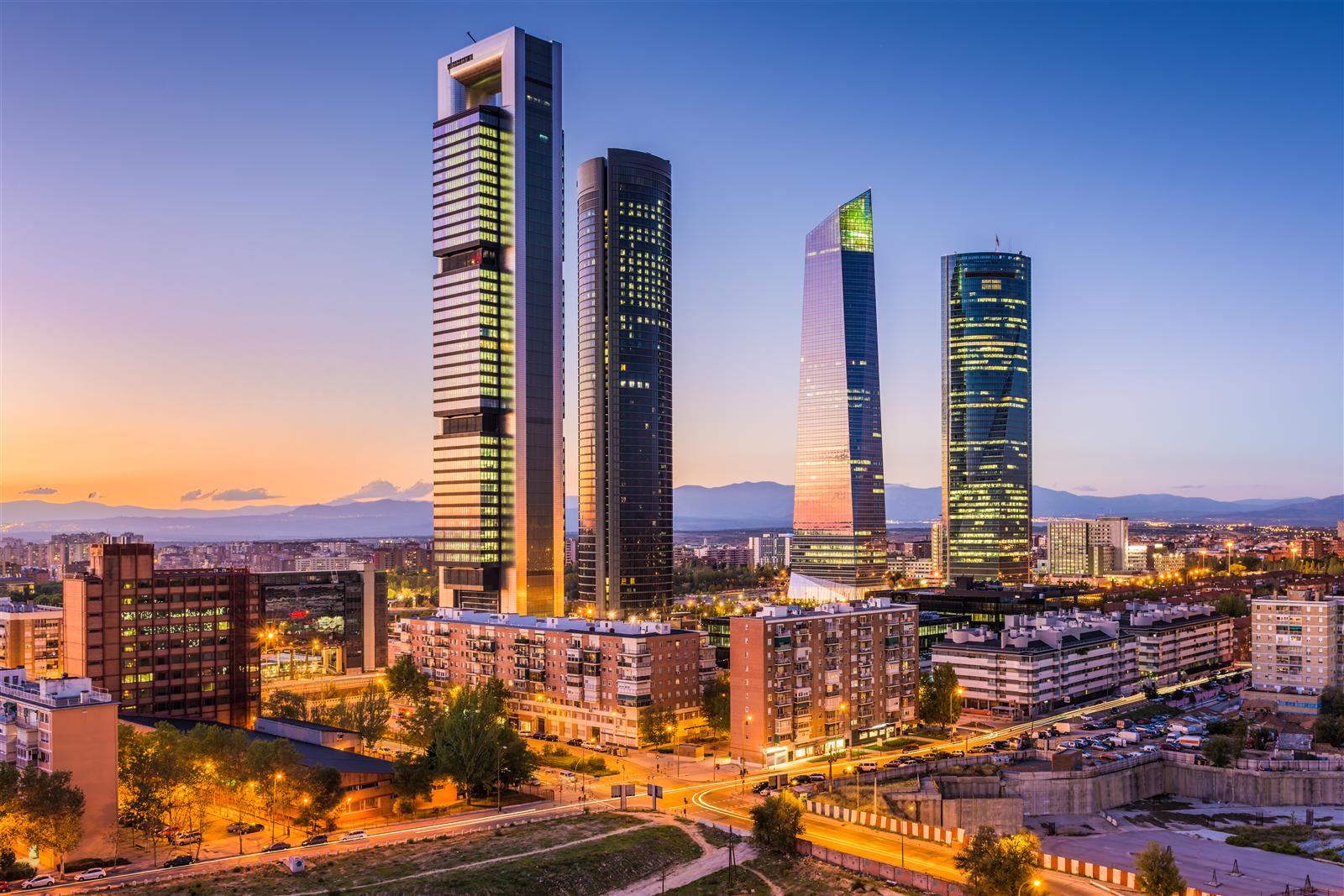 The Cuatro Torres business district in Madrid at dusk